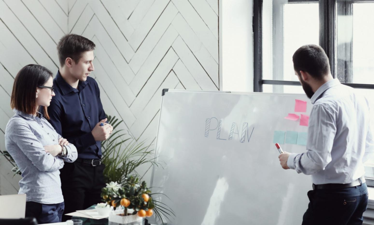 Financial professional analyzing complex data charts and business metrics on multiple screens